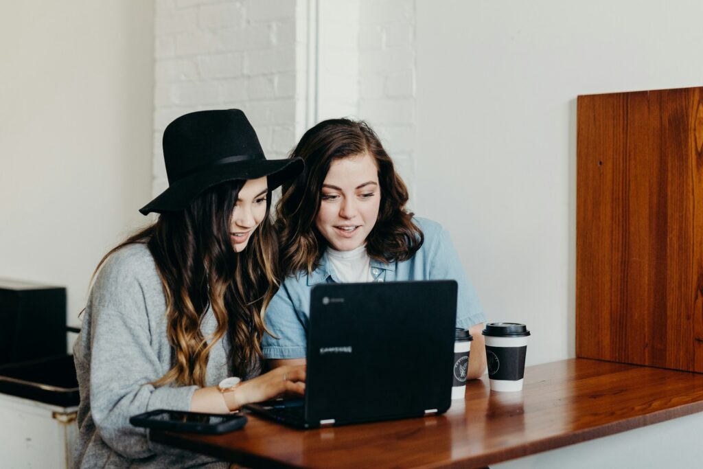 two women looking at computer