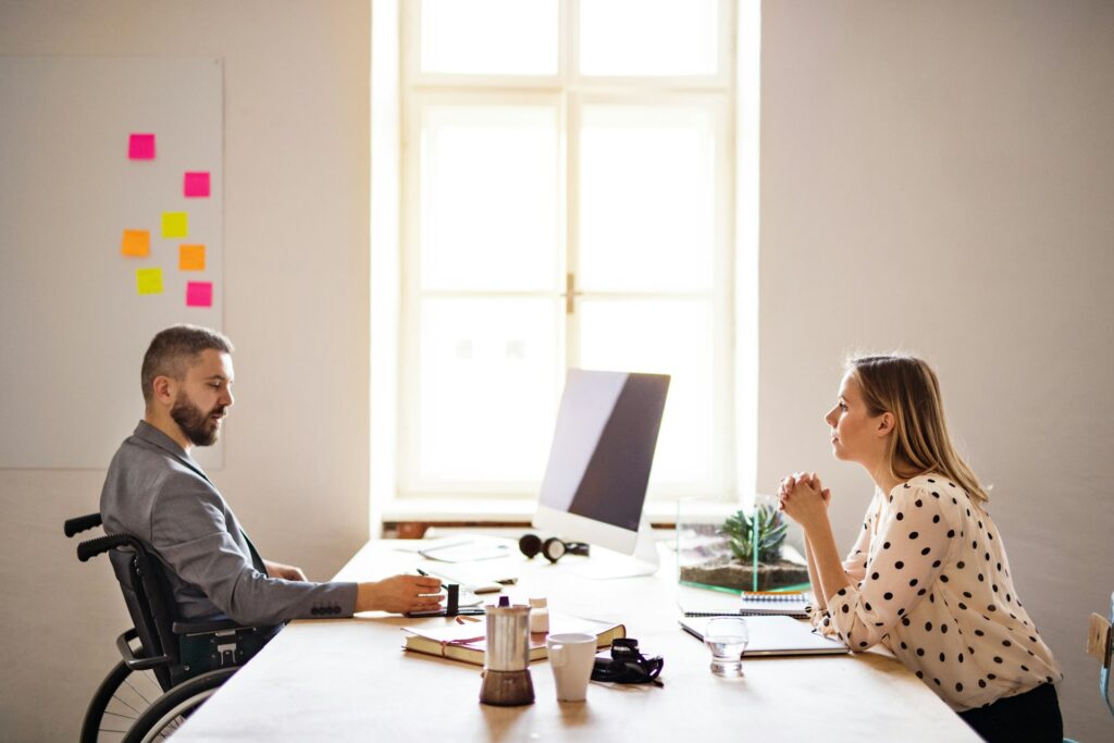 male and female colleagues sitting across desk