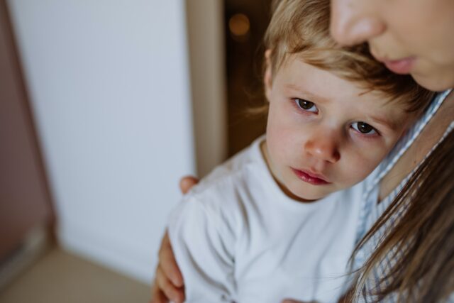 sad boy being comforted by his mother