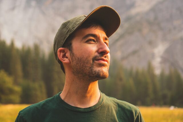 smiling man looking up to sun