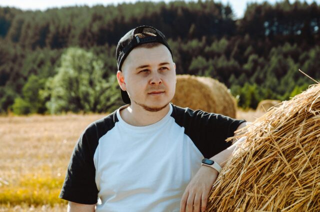 man alone against hay bale