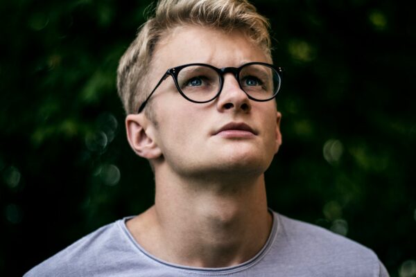 serious guy in glasses looking up