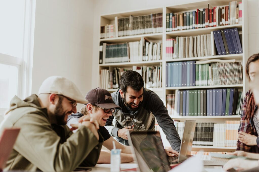 millennial male colleagues working on laptops