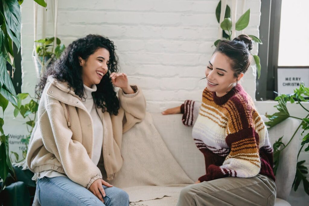 two female friends chatting on couch